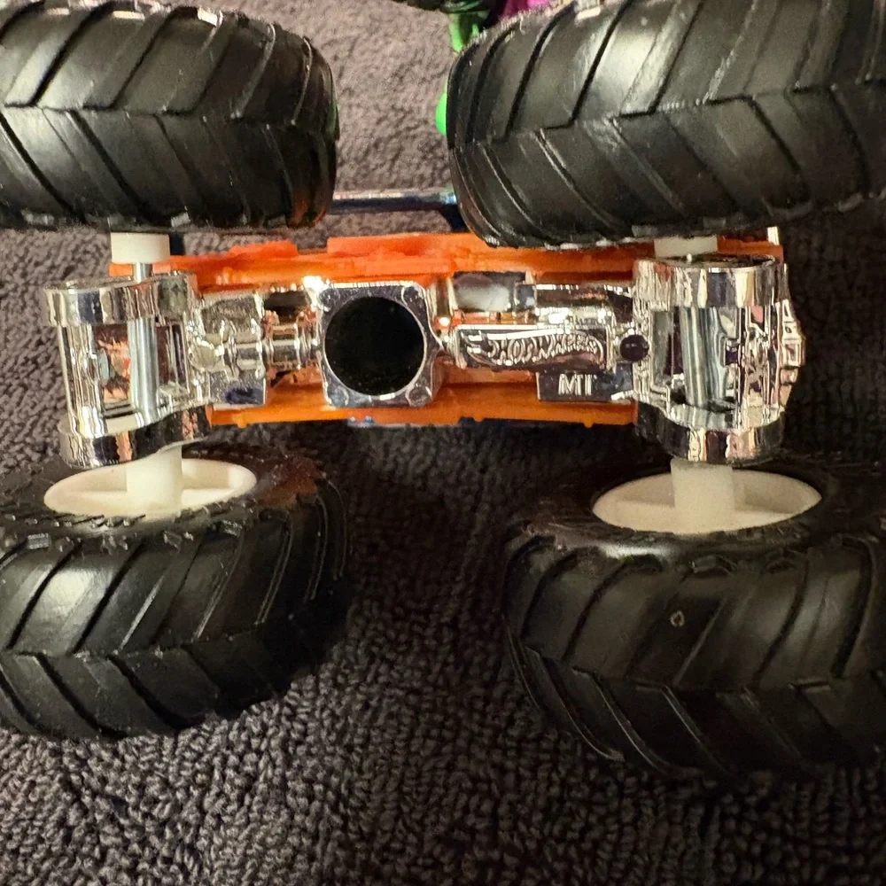 Hot Wheels 4 lot of Monster Truck Toys. Assorted Colors (Green, Orange, Blue)